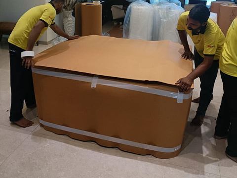 Team covering a table with corrugated sheet