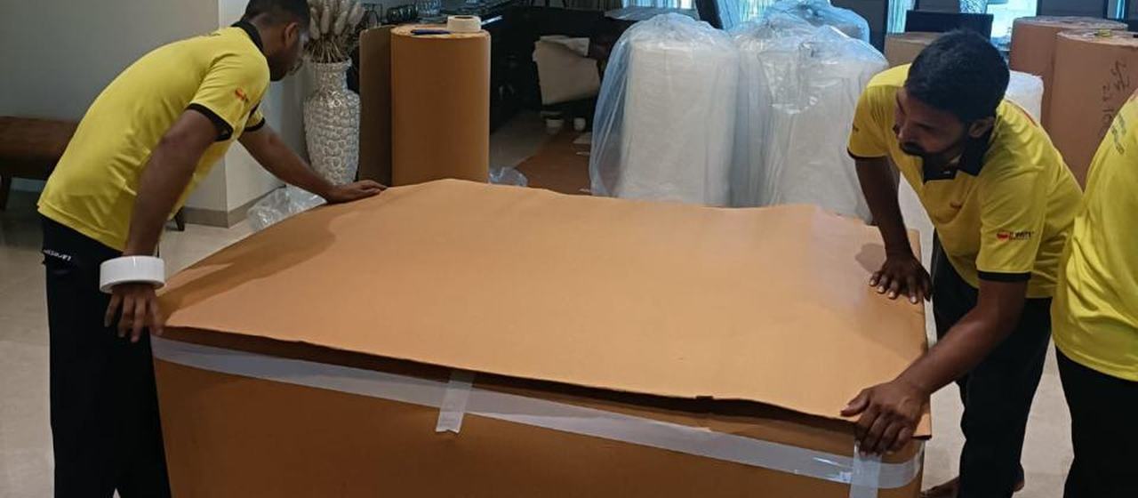Team covering a table with corrugated sheet