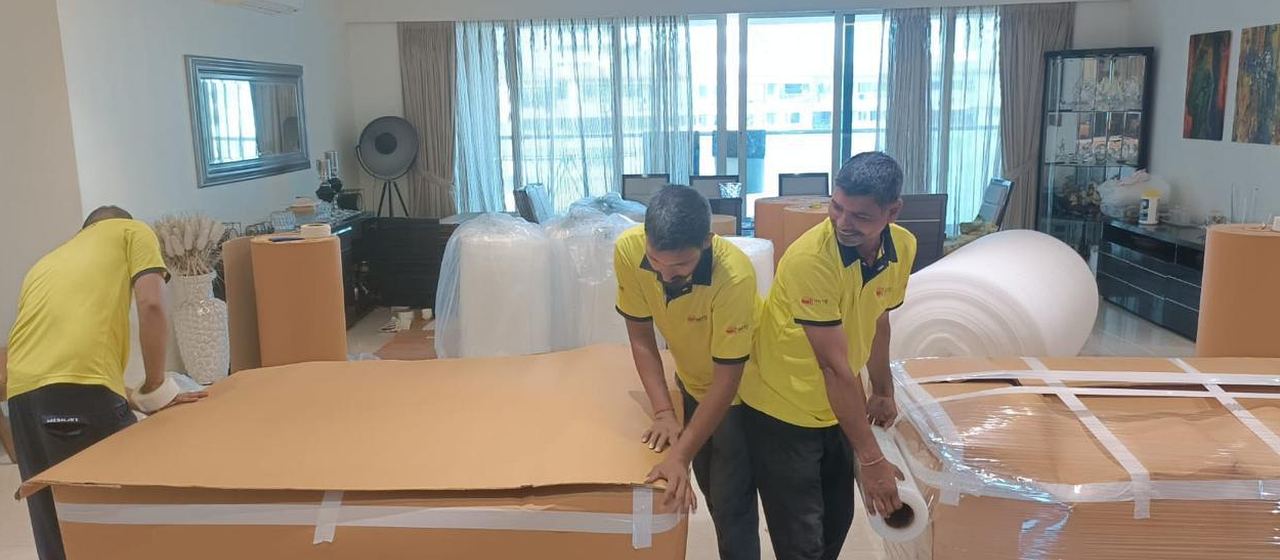 Team wrapping furniture in a customer's home