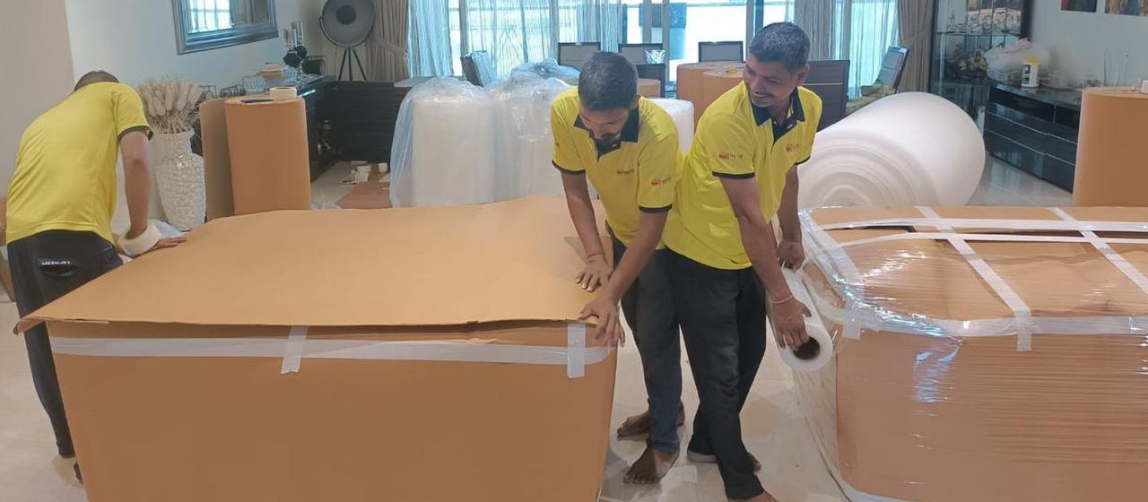 Team wrapping furniture in a customer's home