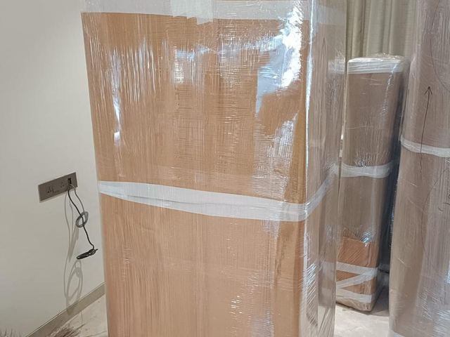Fridge wrapped in corrugated sheet and stretch film