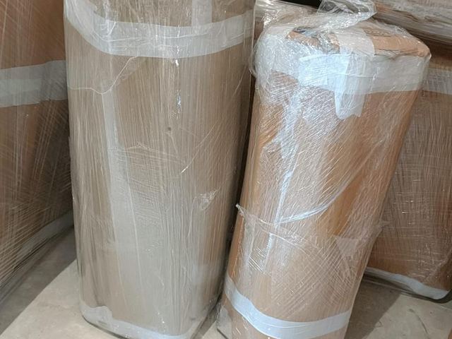 Items wrapped in corrugated sheet and film