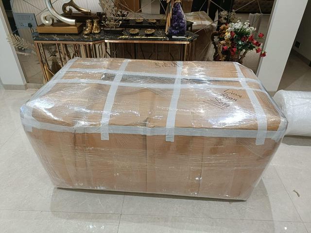 Sofa wrapped and labelled for the living room