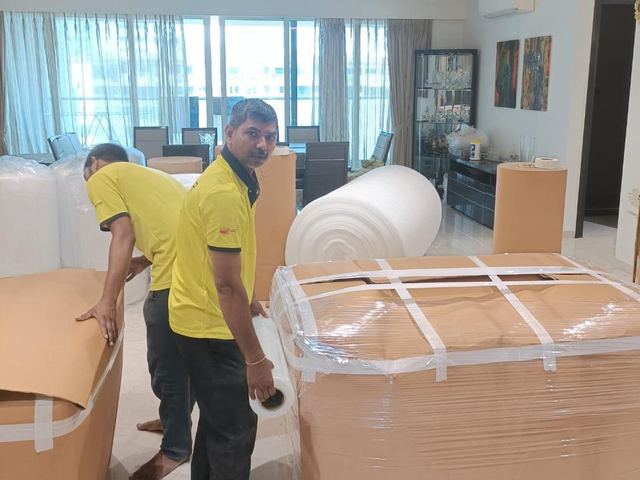 PN Writer team wrapping a table with stretch film